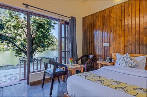 a bedroom with a bed and a view of the water at By the Lake Boho Bhimtal in Bhīm Tāl