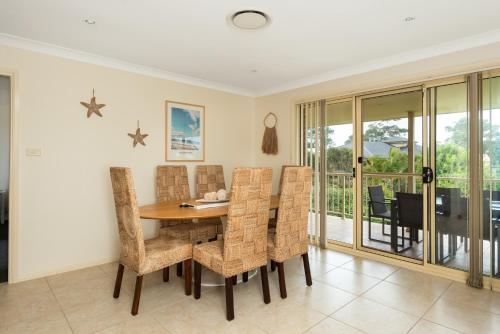 a dining room with a table and chairs at You, Me & The Sea - Walk to Mollymook Beach in Mollymook