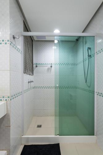 a shower with a glass door in a bathroom at Caribe Carioca in Rio de Janeiro