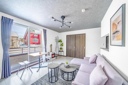 a living room with a couch and a table at Hills Niseko 106 in Niseko