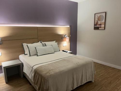 a bedroom with a large bed with a large headboard at Stay Santos 2301 in Santos