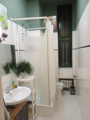 a bathroom with a shower and a sink and a toilet at Ku'damm Taler's Central - Self Check In in Berlin
