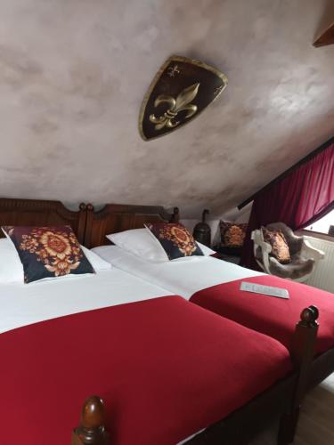 a bedroom with two beds and a ceiling at Hraško in Rimavská Sobota