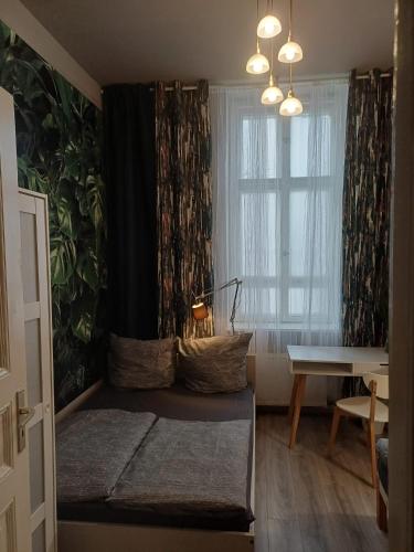 a room with a bed and a window and a table at Ku'damm Taler's Central - Self Check In in Berlin