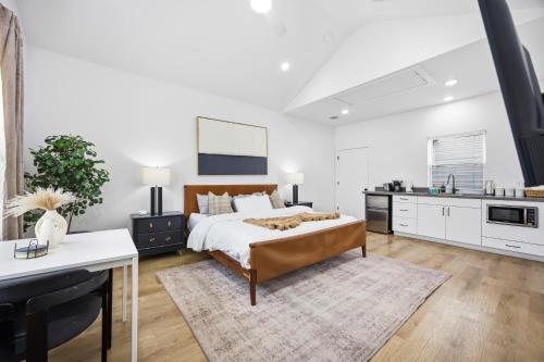 a bedroom with a bed and a kitchen at Boho-Mod Studio at East Downtown in Houston