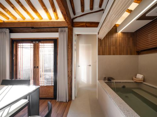 a bathroom with a swimming pool and a tub at Luxury Hanok The four beauties seochon in Seoul