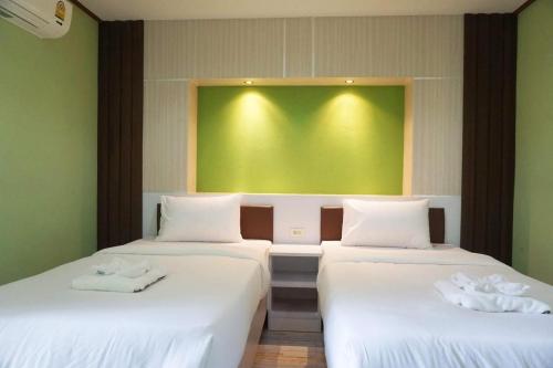 Postel nebo postele na pokoji v ubytování Honey Hotel Chiang Saen
