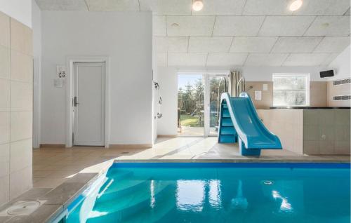 a pool in a kitchen with a blue slide in a house at Amazing Home In Idestrup With Sauna in Bøtø By