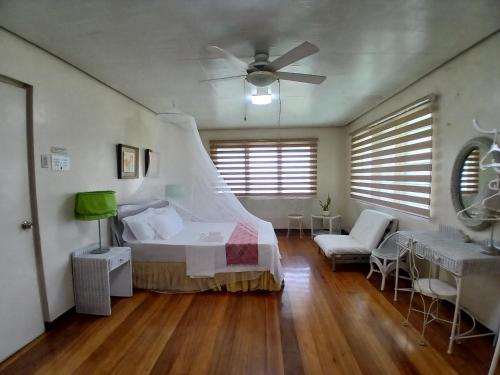 a bedroom with a bed and a ceiling fan at Casa Joaquin BnB in Manila