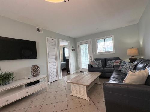 a living room with a couch and a table at Family Getaway - Boardwalk to the Beach, 3 pools, Tennis in Hilton Head Island
