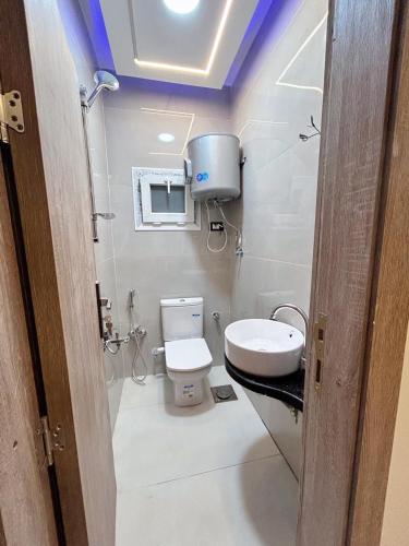 a small bathroom with a toilet and a sink at Comfy 3 Bedrooms Apartment in Cairo Sheraton Airport in Cairo