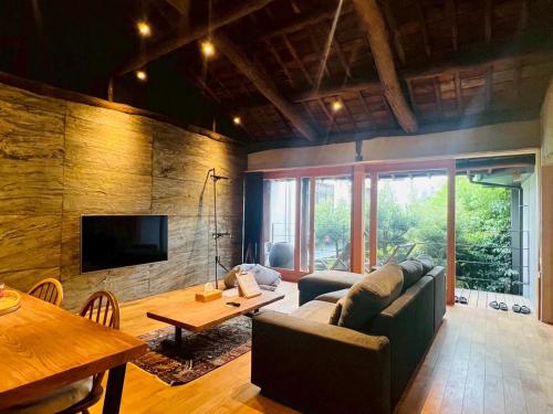 a living room with a couch and a table at Onomichi SINGAI HOSTELS in Onomichi