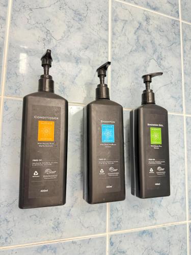 three bottles of detergent are sitting on a counter at Centrepoint Motor Inn in Rockhampton