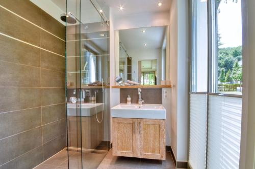 a bathroom with a sink and a mirror at Ferienwohnung Baltic Lounge in der Villa Amalie Binz in Binz
