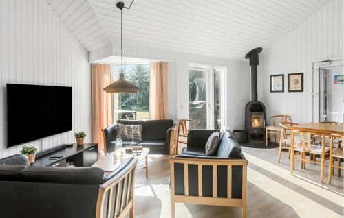 a living room with a couch and a tv at Amazing Home In Idestrup With Sauna in Bøtø By