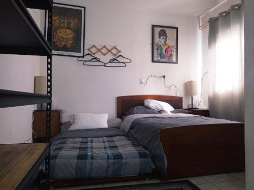 a bedroom with two beds and a lamp and a window at Casa Capuchina in Querétaro