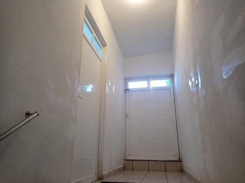 a bathroom with a shower and a door with a window at Casa Capuchina in Querétaro