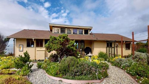 a house with a garden in front of it at Tideaway Private Hot Tub and Expansive Ocean View in Fort Bragg