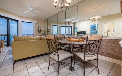 a dining room and living room with a table and chairs at Phoenix VI 61204 in Orange Beach