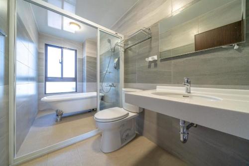 a bathroom with a toilet and a sink and a shower at Sunlight Orchid Rain Homestay in Dongshan