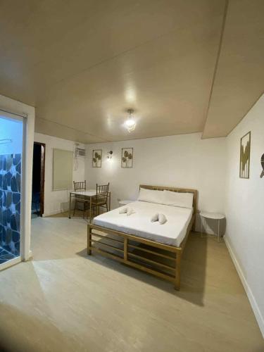 a bedroom with a bed in the middle of a room at Eco Homes in Panglao Island
