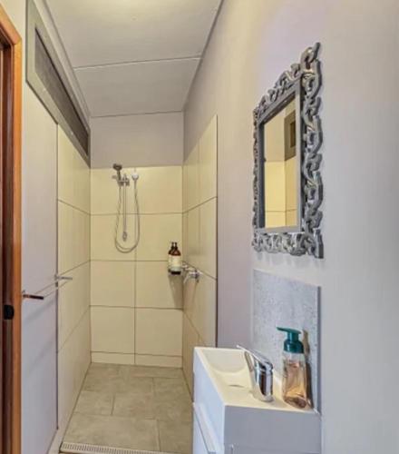a white bathroom with a sink and a shower at Horseshoe Haven in Horseshoe Bay