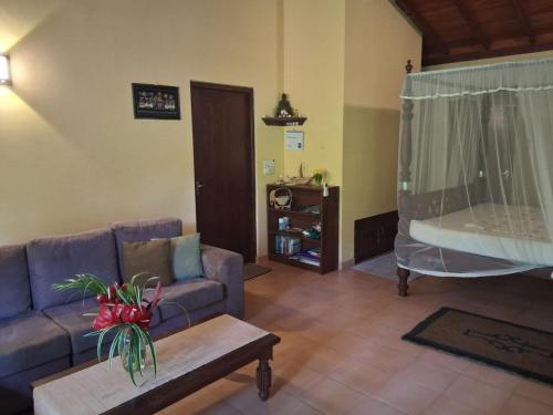 a living room with a couch and a table at Mallis Guesthouse in Habaraduwa Central