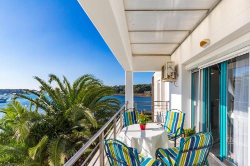 a balcony with a table and chairs overlooking the water at Marija Marković Medulin A15 in Medulin