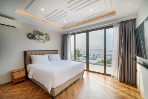 a bedroom with a bed and a large window at SEA TO SKY Villa - 4 Bedrooms Ocean View in Pulau Nongsa