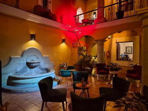 a restaurant with a pool in the middle of a room at Hotel Casa Divina Oaxaca in Oaxaca City