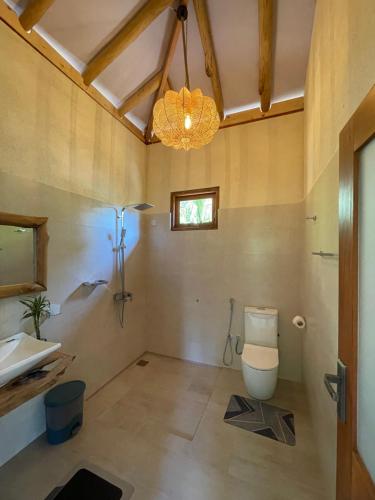 a bathroom with a toilet and a sink at Treetops ella in Ella
