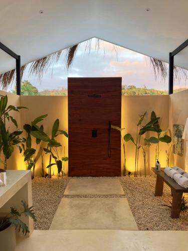 a wooden door in a room with some plants at Lasa, private villa with private pool in El Nido