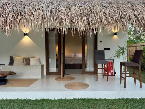 a room with a bed and a straw roof at Lasa, private villa with private pool in El Nido