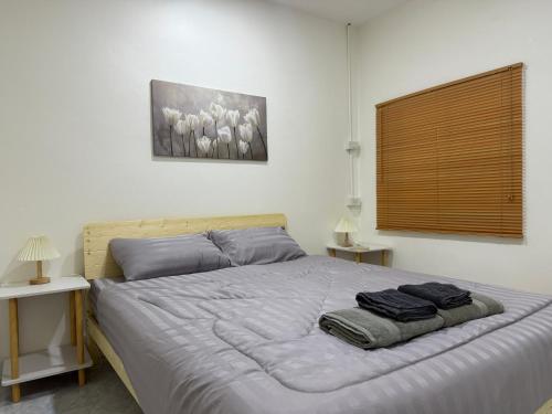 a bedroom with a bed with two towels on it at Summer Sand in Haad Rin