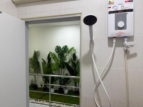 a bathroom with a hair dryer attached to a wall at Summer Sand in Haad Rin