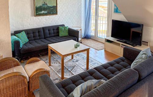 a living room with a couch and a table at 1 Bedroom Gorgeous Apartment In Samsø in Ballen