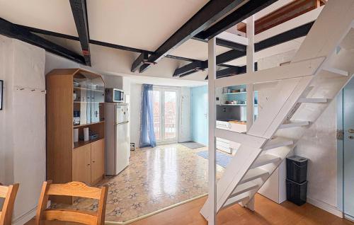 a white staircase in a room with a kitchen at 1 Bedroom Gorgeous Apartment In Samsø in Ballen