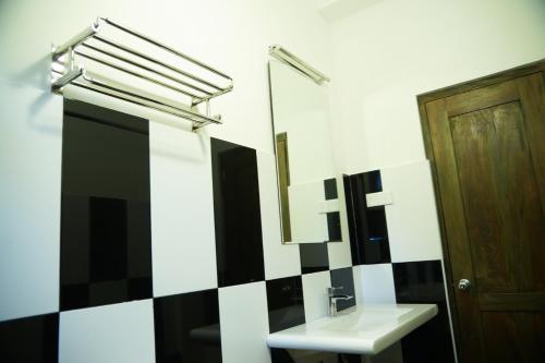 a bathroom with a sink and a mirror at Kandy Moon Hills Hotel in Kandy