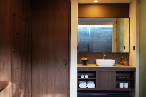 a bathroom with a sink and a mirror at Tanna Villa Bali Tabanan in Krambitan