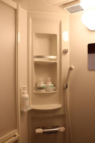 a bathroom with a refrigerator with two bottles of soap at Essai B&B - Quiet Village Retreat in Gokayama, near Shirakawa-go in Nanto