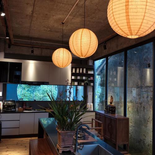 a kitchen with two orange lights and a counter at Limu Mountain Forest Park in Hainan
