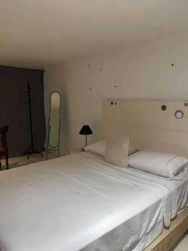a bedroom with a large bed with white sheets at Saada in Tangier