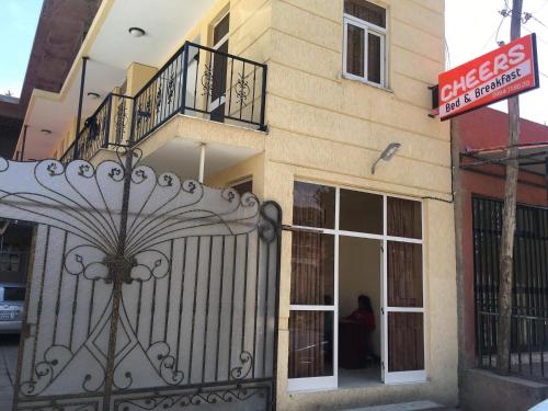 a building with a gate in front of a store at Cheers Bed & Breakfast in Addis Ababa