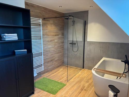 a bathroom with a shower and a bath tub at Beehome Wietzendorf in Wietzendorf
