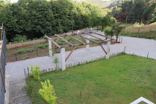 a garden with a wooden structure in a yard at Quinta da Costa in Lixa