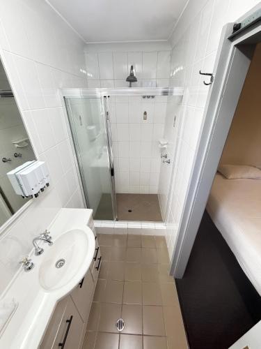 a bathroom with a shower and a sink at Centrepoint Motor Inn in Rockhampton