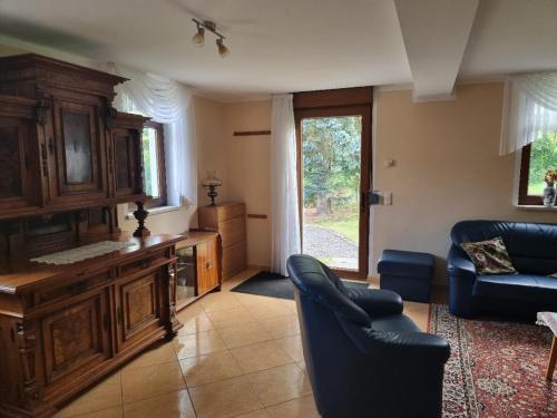 a living room with a couch and a table at Wunderschöne Ferienwohnung in Thüringen in Langenorla