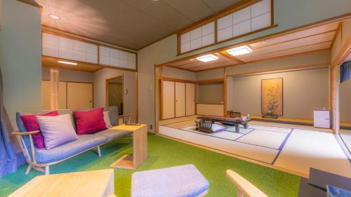 a living room with a couch and a table at Yoshiike Ryokan in Hakone