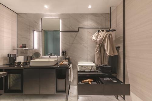 a bathroom with a sink and a mirror at The Outpost Hotel Sentosa by Far East Hospitality in Singapore