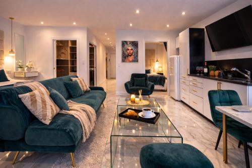a living room with a green couch and a table at Luxury Maubourg - Vue mer - Croisette 50m plage - Clim - terrasse in Cannes